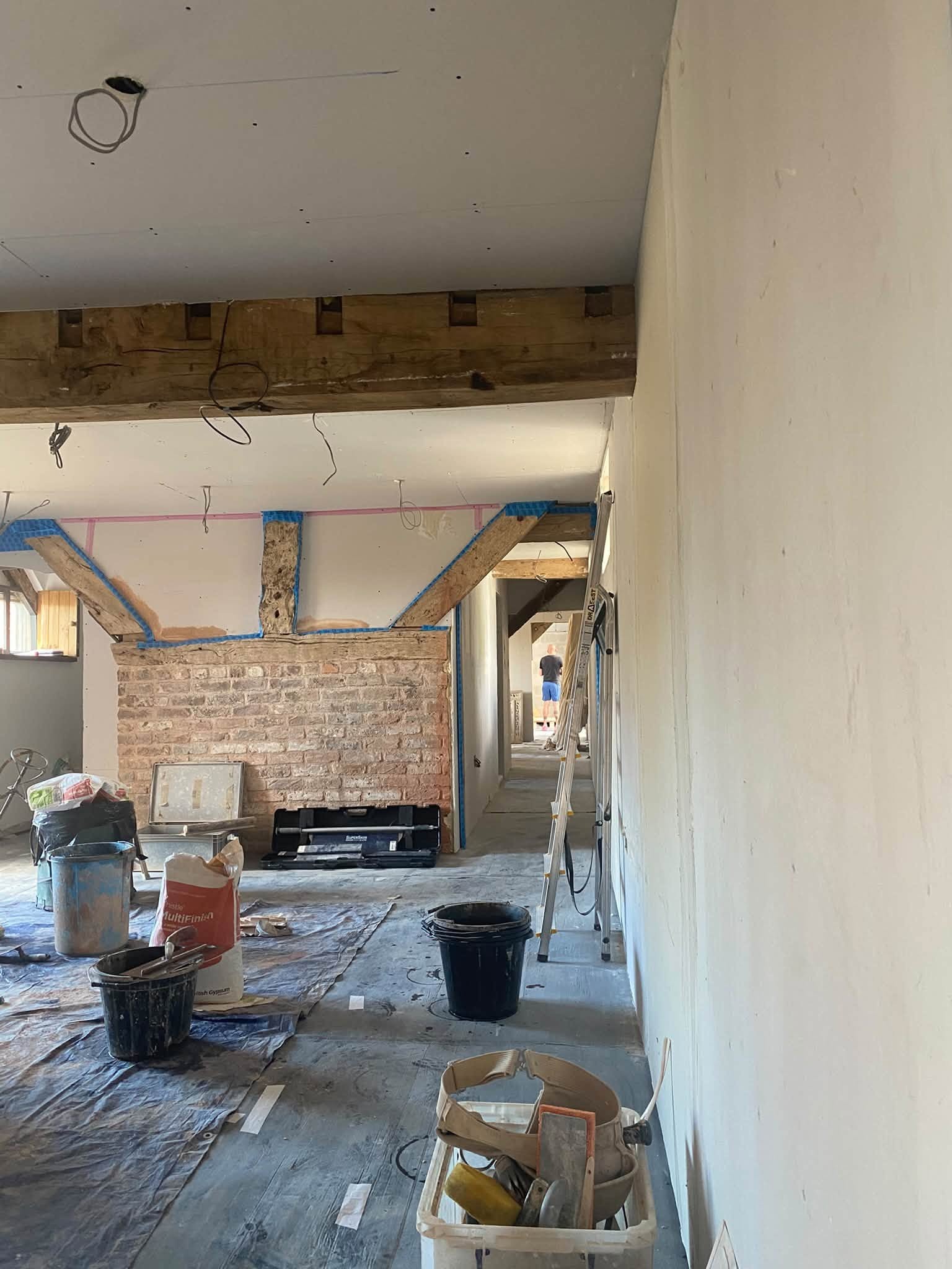 Cottage interior in Ellesmere with oak beams, exposed brick and freshly plastered walls