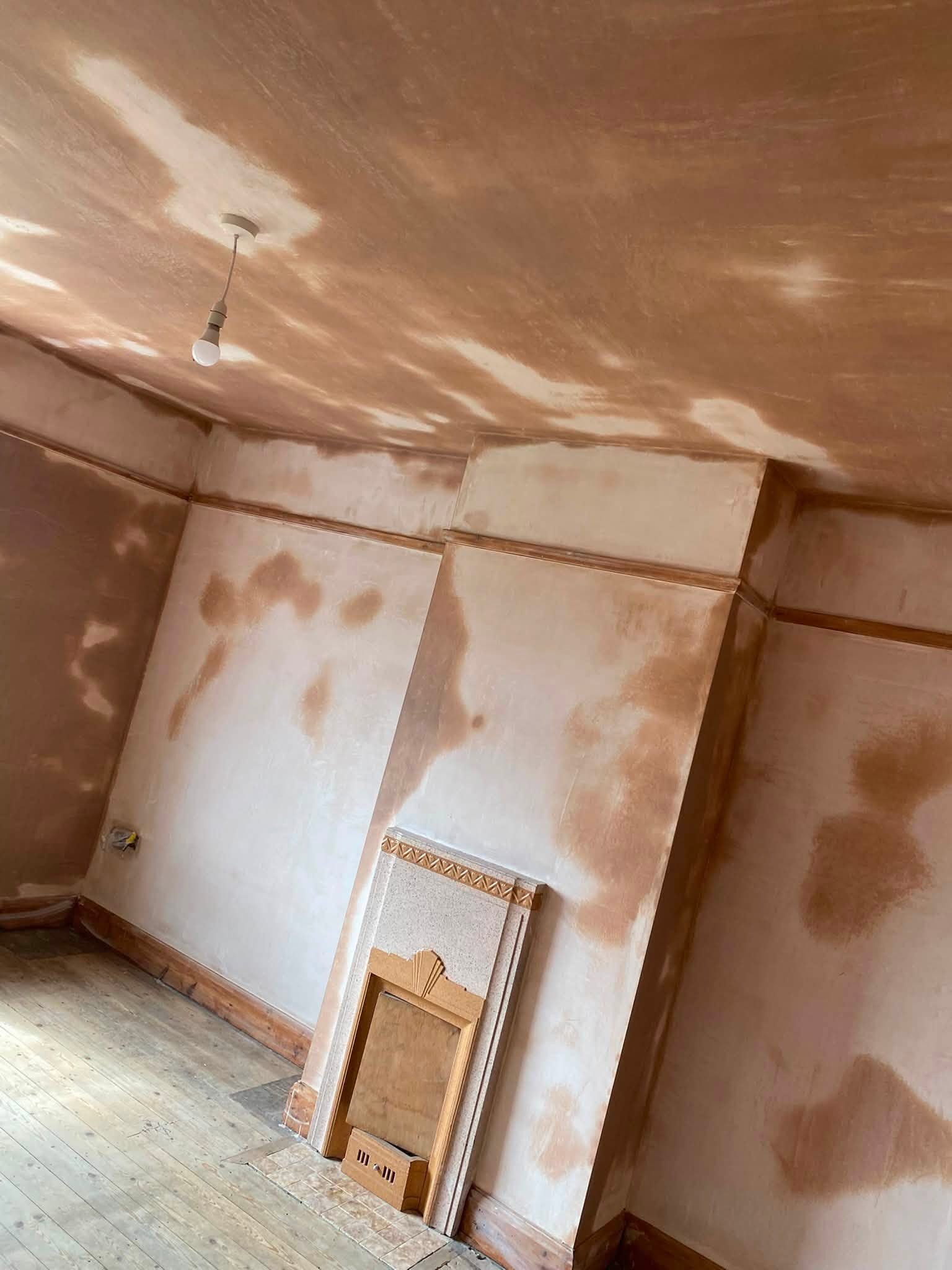 Chimney breast and alcoves in Oswestry with fresh plaster drying in patches