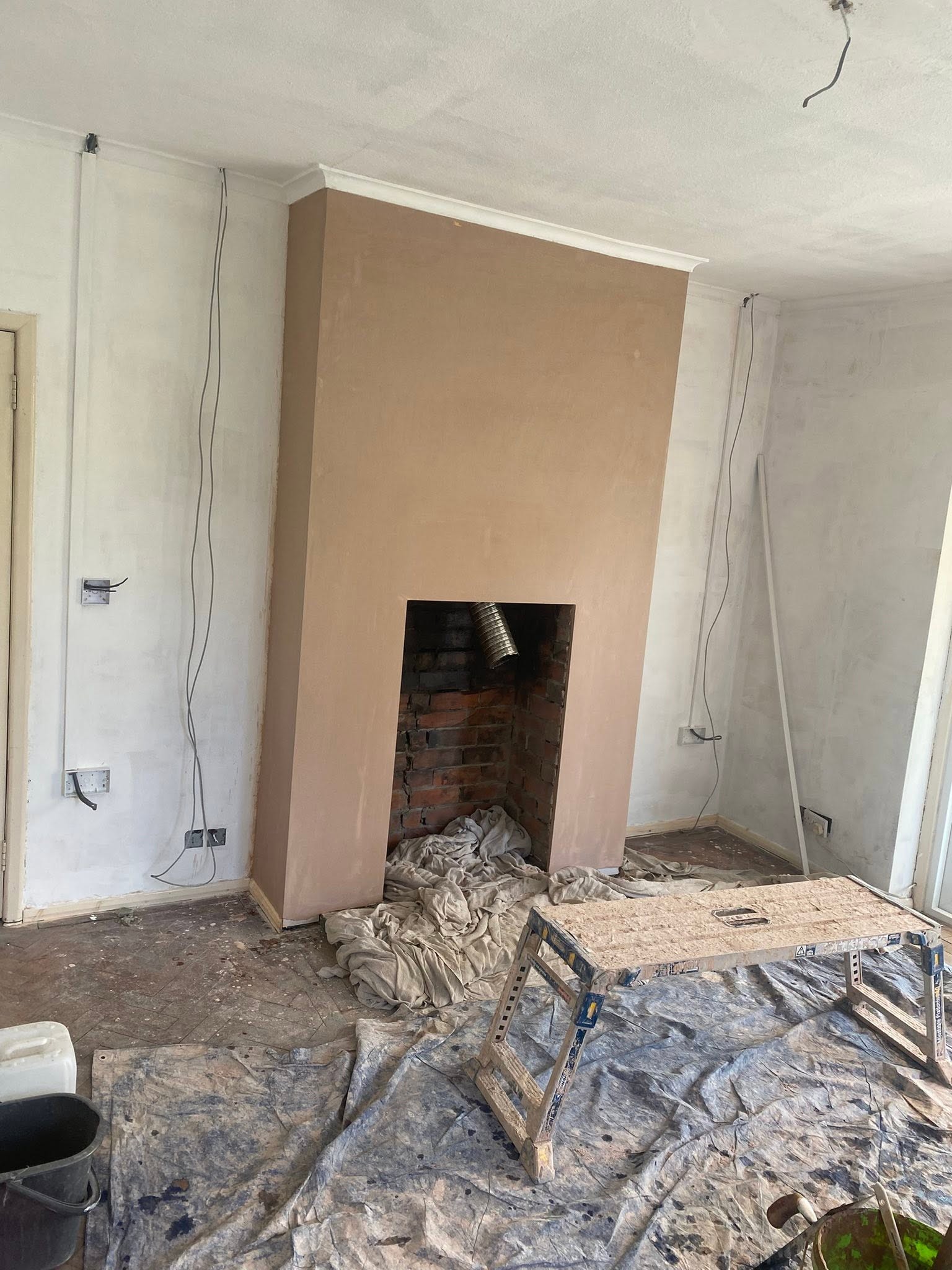 Chimney breast in Trefonen finished in fresh plaster from a side angle