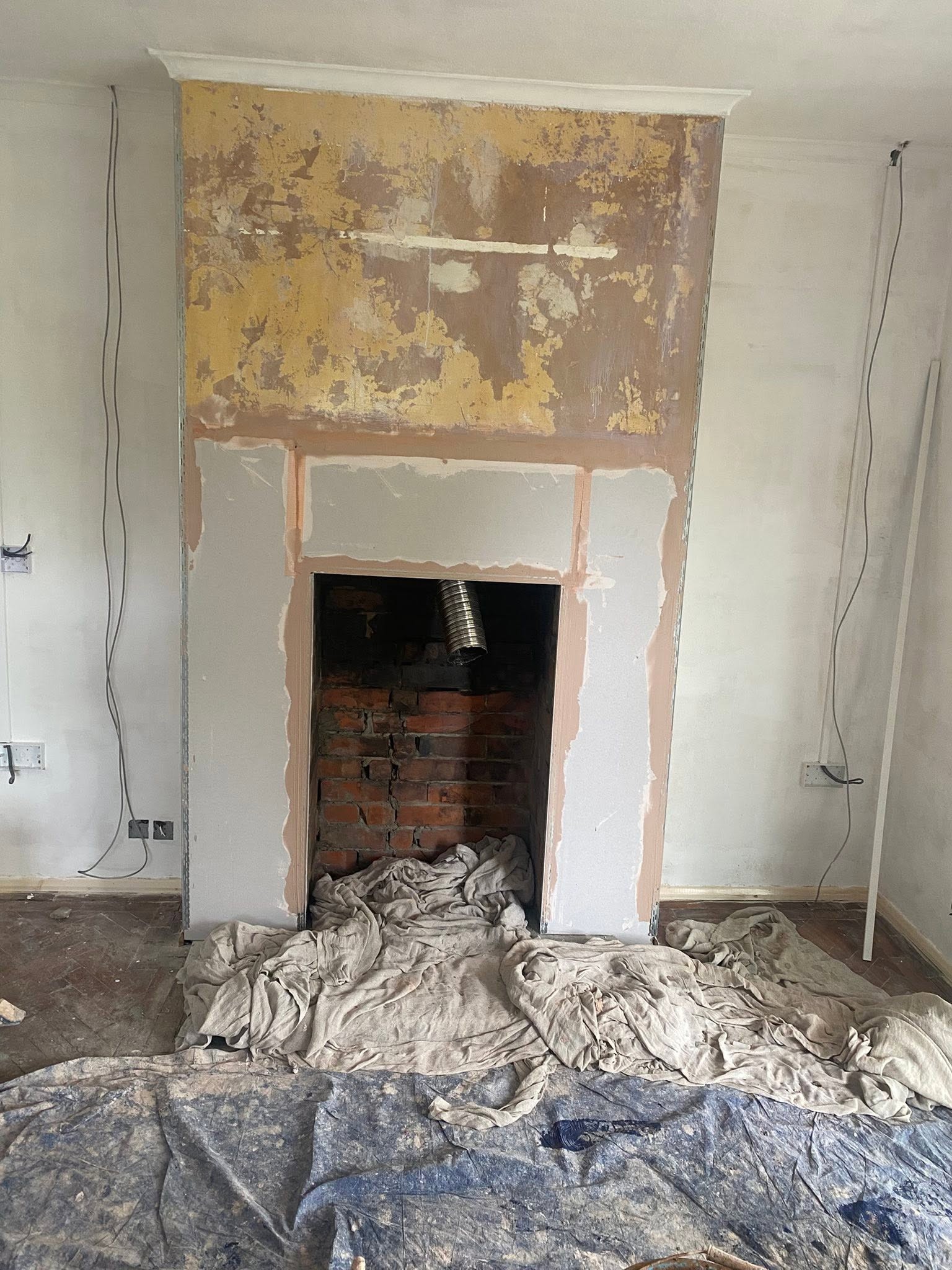 Chimney breast in Trefonen part way through, new boards round the fireplace opening