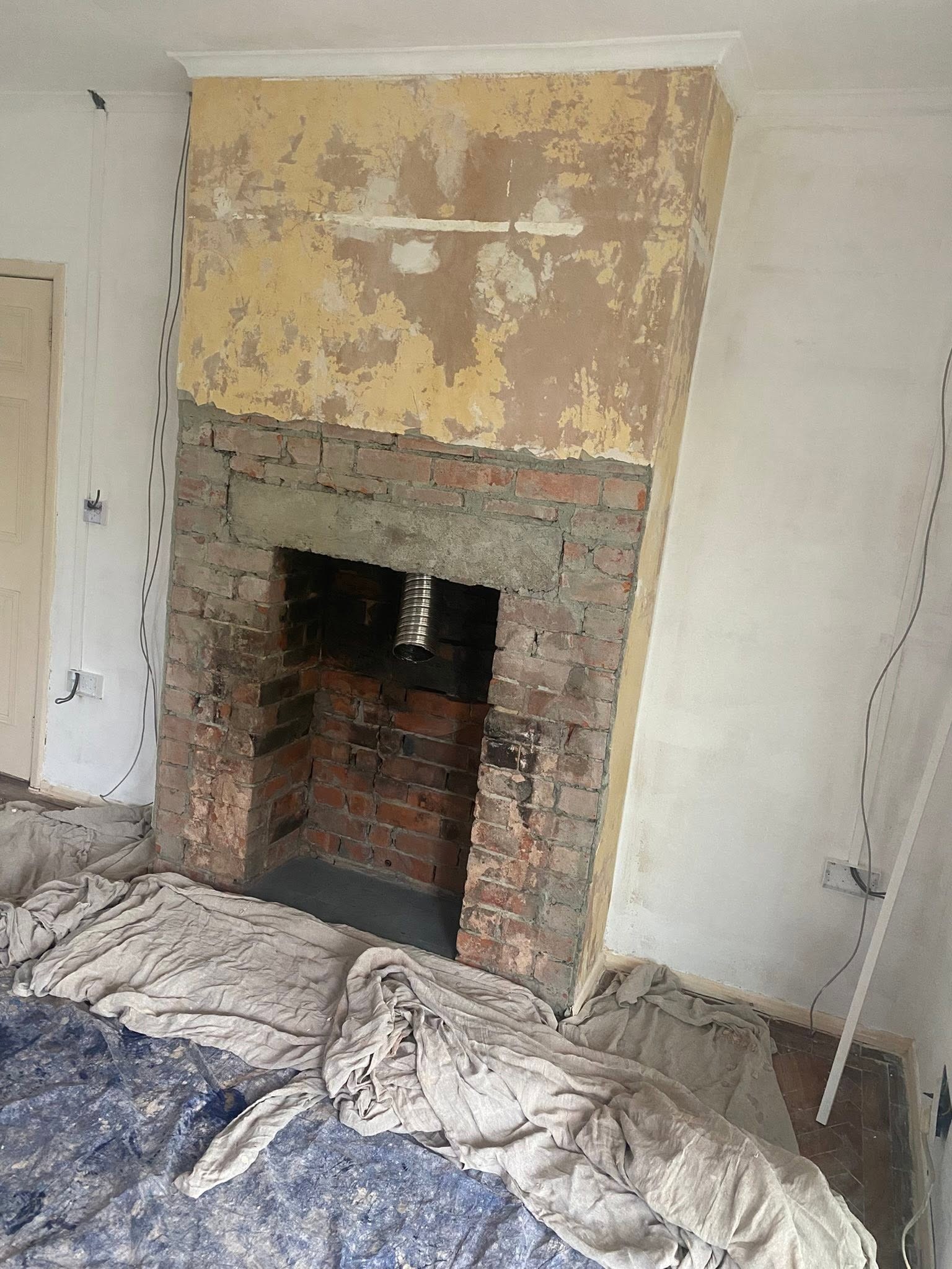 Chimney breast in Trefonen stripped back to bare brick before plastering