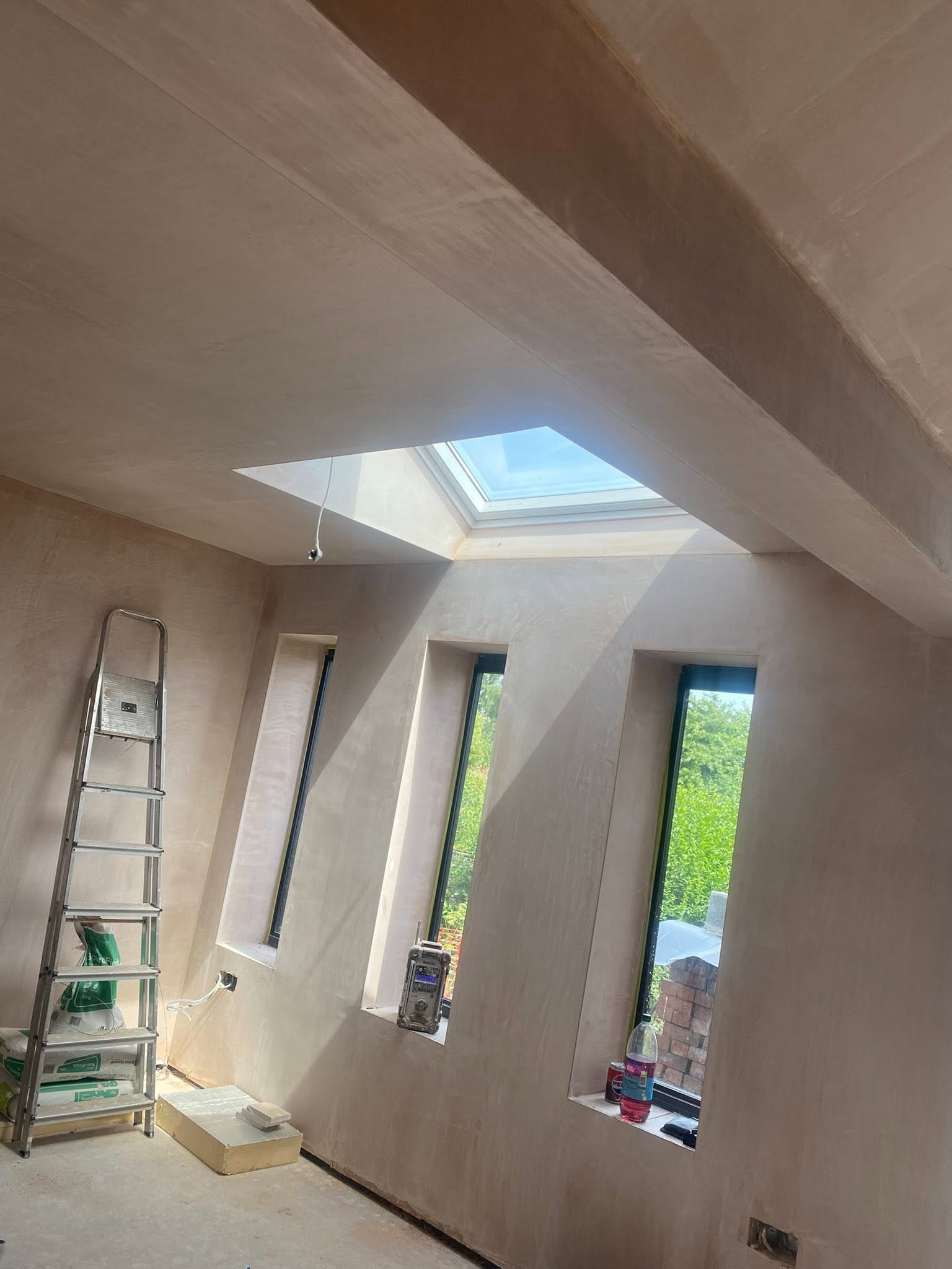 Extension in Saint Martins with a roof lantern and slot windows, walls and ceiling freshly plastered