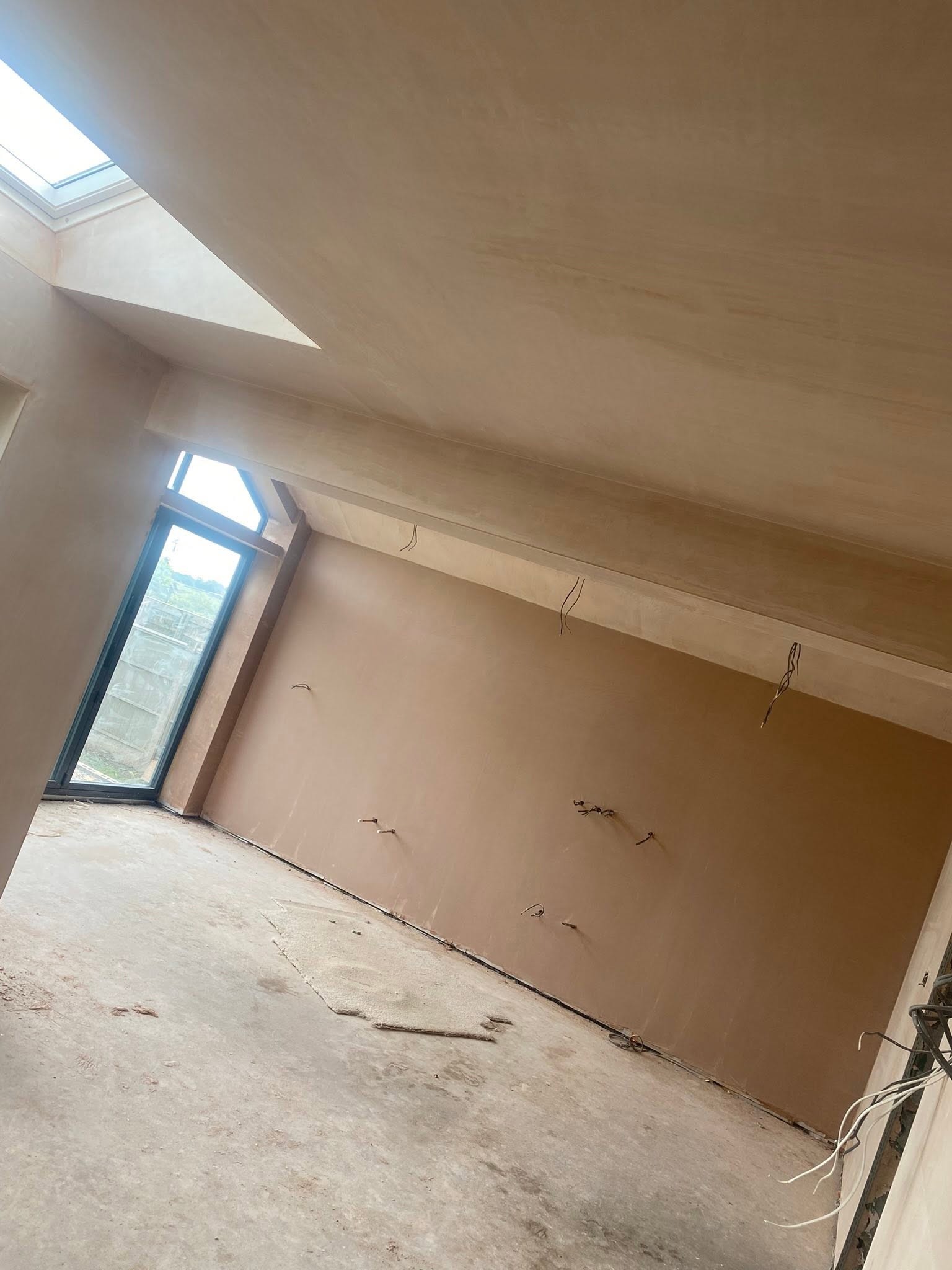 Side wall of the Saint Martins extension plastered under the sloping ceiling