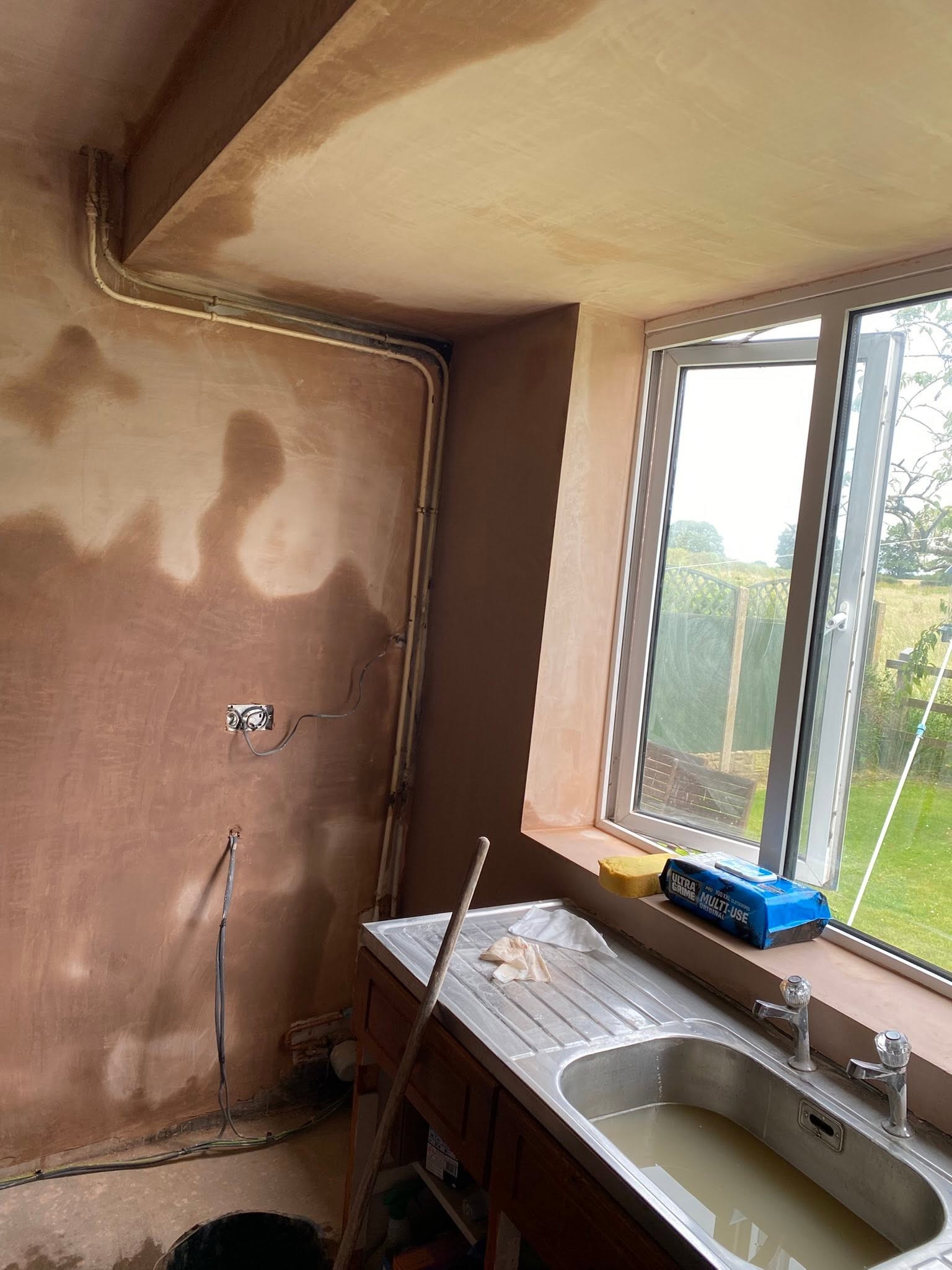 Kitchen in Saint Martins with fresh plaster beside the sink and window