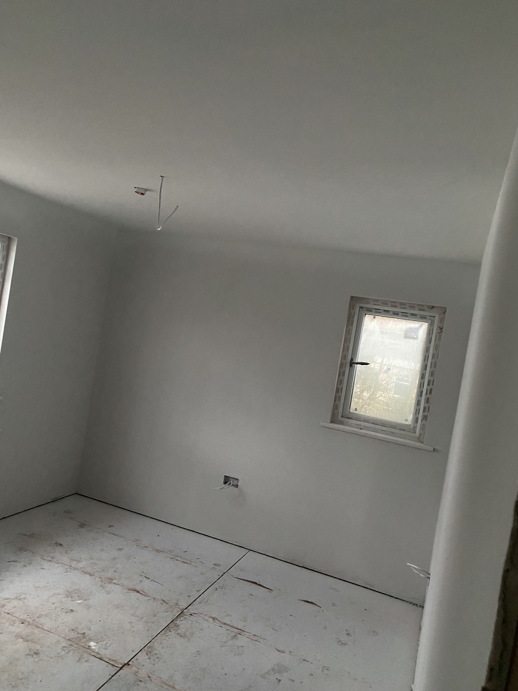 New-build bedroom with smooth plastered walls and ceiling