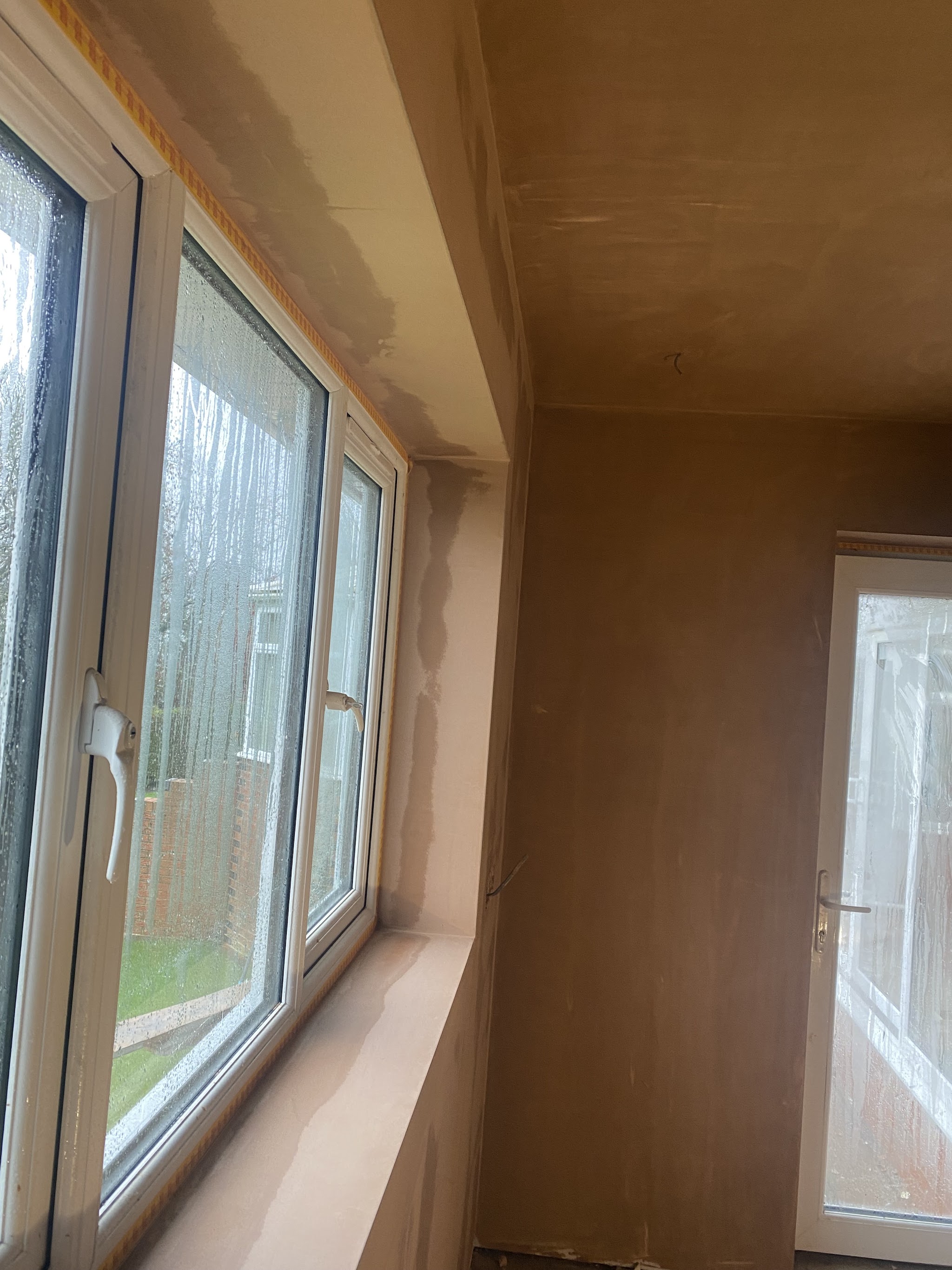 Tall window reveal and walls in fresh plaster