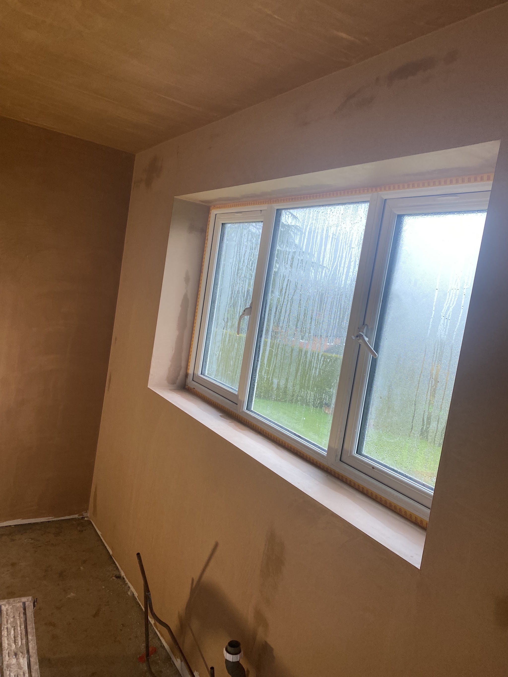 Wide window reveal and walls in fresh plaster